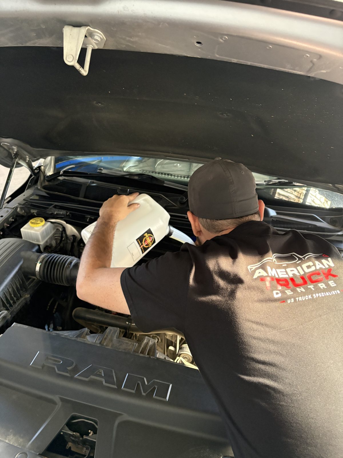 Engine oil being poured into a RAM 1500 Hemi during servicing