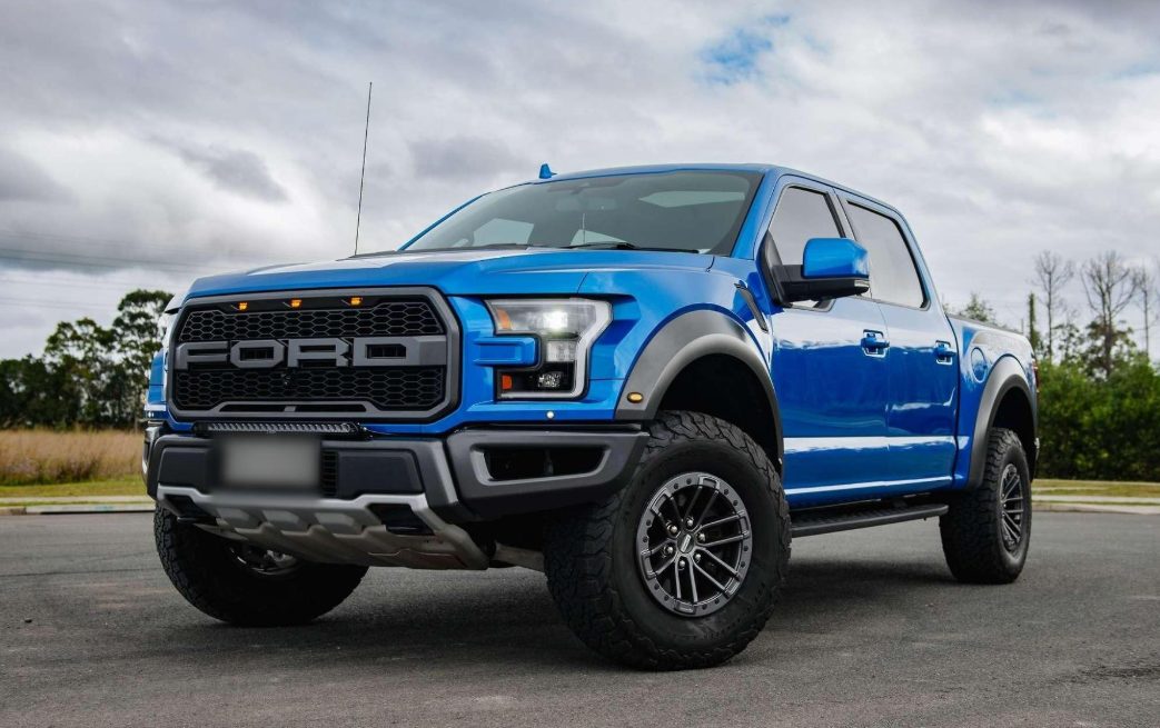 Blue Ford F-150 Raptor parked outdoors
