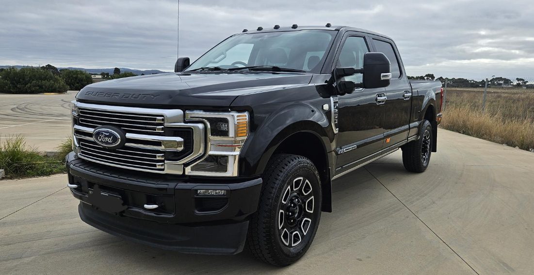 Black Ford Super Duty side profile outdoors