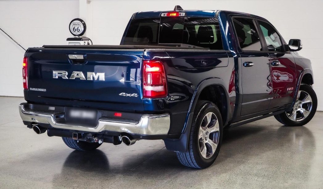 Blue RAM 1500 rear three-quarter view with tow bar
